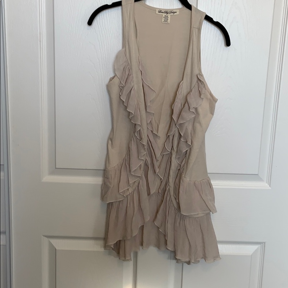 Adorable vest with ruffles.